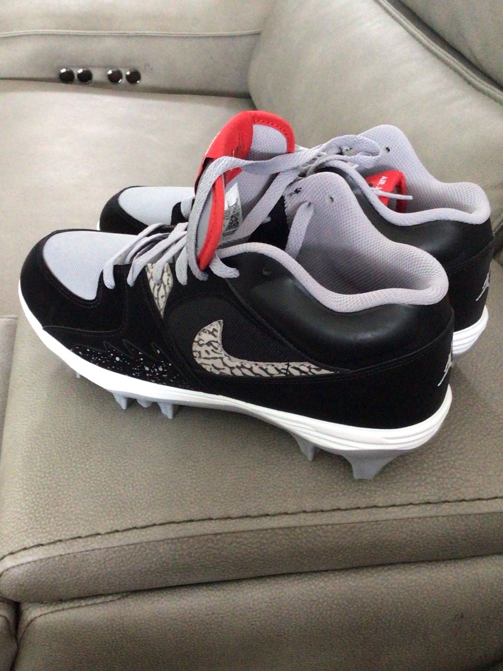 Nike mens Black and Gray Baseball Cleats with Red Tongue Accent
